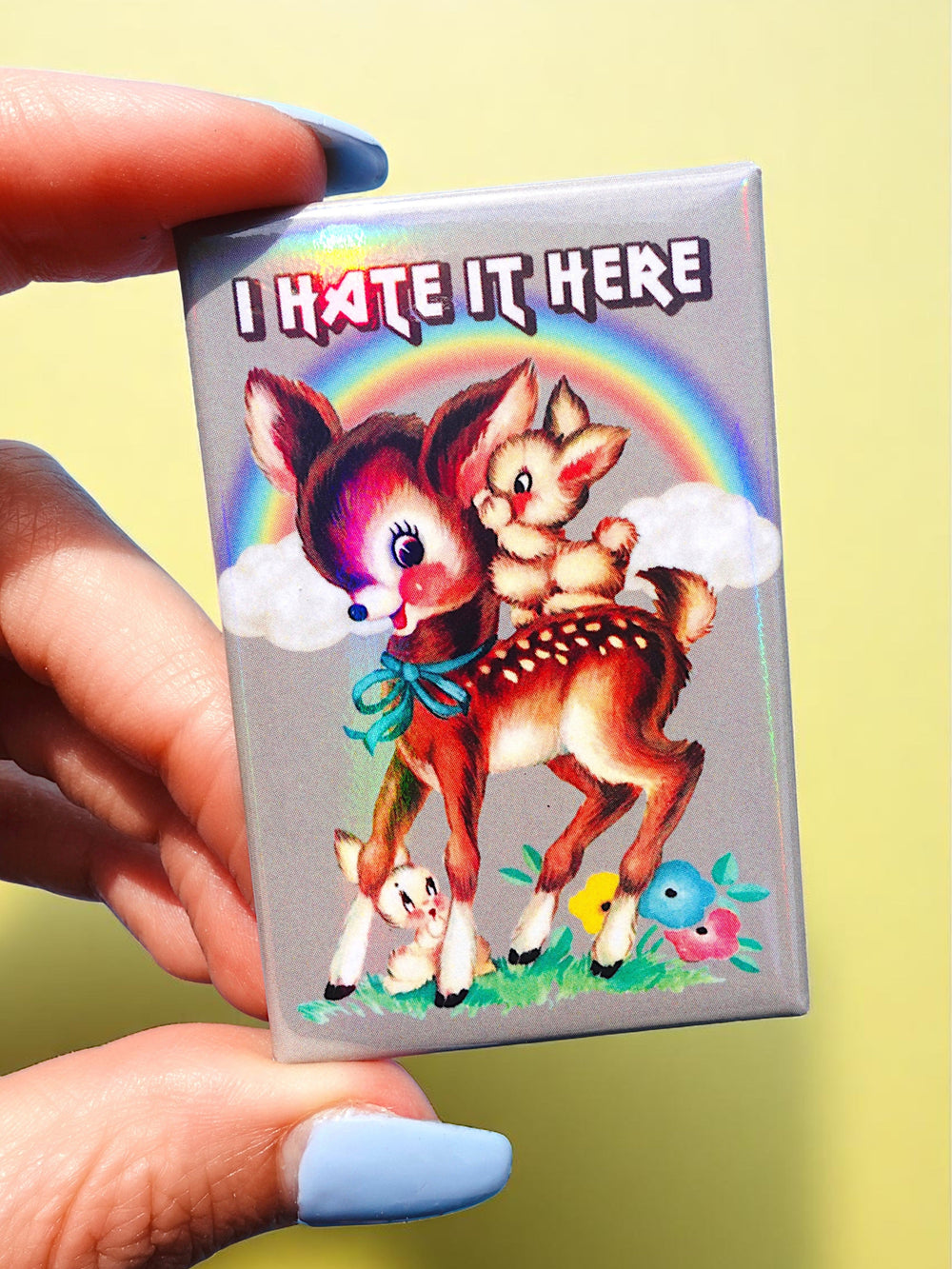 I Hate It Here Holographic Pin – Retro Rainbow Deer with Dark Humor